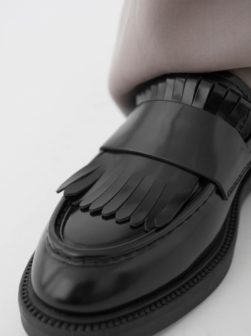 A detail view of Cosmo 2.0 loafers in Bordeaux leather, with tassels and fringe details