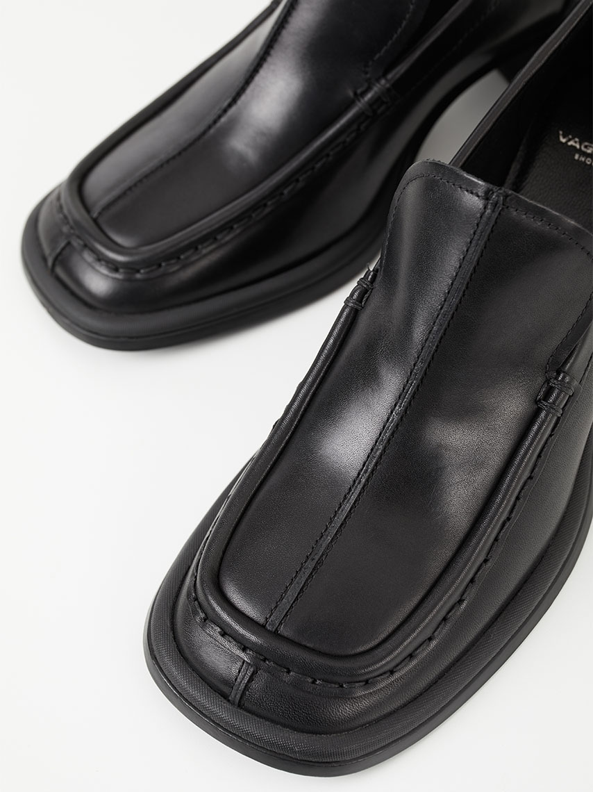 A detail view of Cosmo 2.0 loafers in Bordeaux leather, with tassels and fringe details